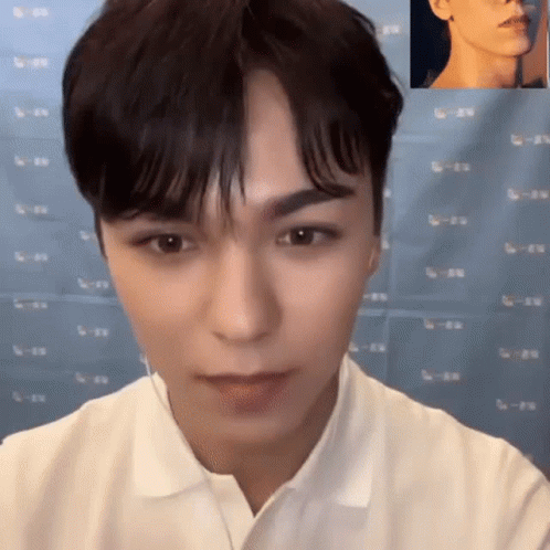 A Close Up Of A Man 'S Face With A Picture Of Another Man 'S Face Behind Him . GIF