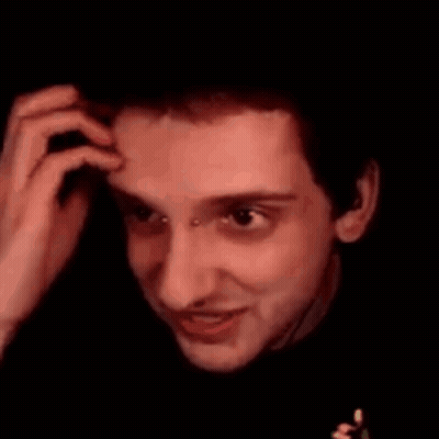 A Close Up Of A Man 'S Face With A Piercing In His Nose Making A Face . GIF