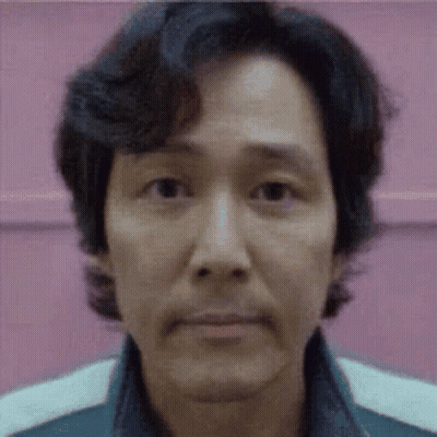 A Close Up Of A Man 'S Face With A Pink Background And A Blurred Background . GIF