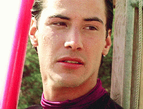 A Close Up Of A Man 'S Face With A Pink Object In The Background GIF