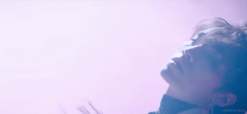 A Close Up Of A Man 'S Face With A Purple Background . GIF