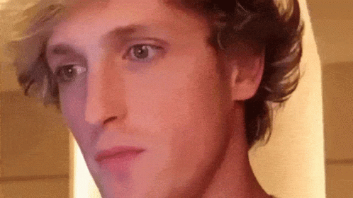 A Close Up Of A Man 'S Face With A Purple Background . GIF