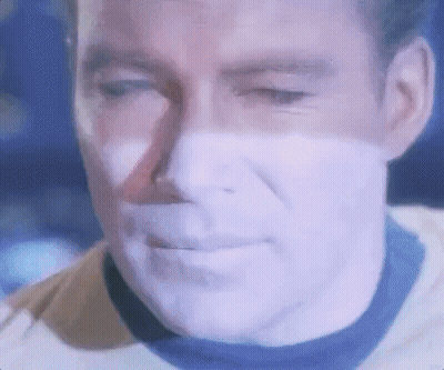 A Close Up Of A Man 'S Face With A Purple Glow On It . GIF