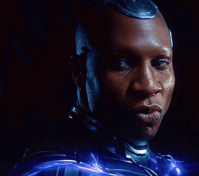 A Close Up Of A Man 'S Face With A Purple Light Behind Him GIF