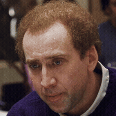 A Close Up Of A Man 'S Face With A Purple Sweater GIF