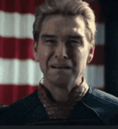 A Close Up Of A Man 'S Face With A Red And White Flag In The Background . GIF