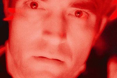 A Close Up Of A Man 'S Face With A Red Background GIF