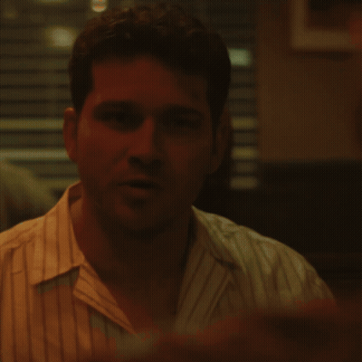 A Close Up Of A Man 'S Face With A Red Background GIF