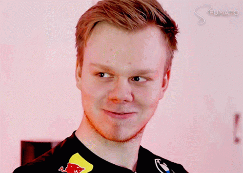 A Close Up Of A Man 'S Face With A Red Bull Logo On His Shirt GIF