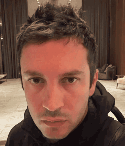 A Close Up Of A Man 'S Face With A Red Face GIF