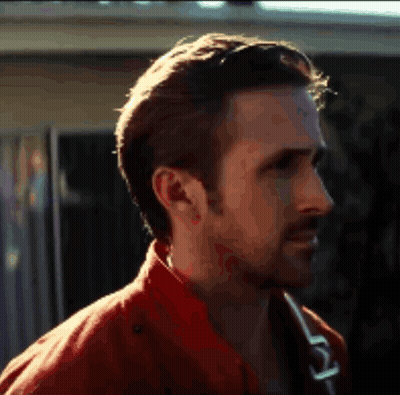 A Close Up Of A Man 'S Face With A Red Jacket On GIF