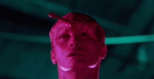 A Close Up Of A Man 'S Face With A Red Liquid Coming Out Of His Head . GIF