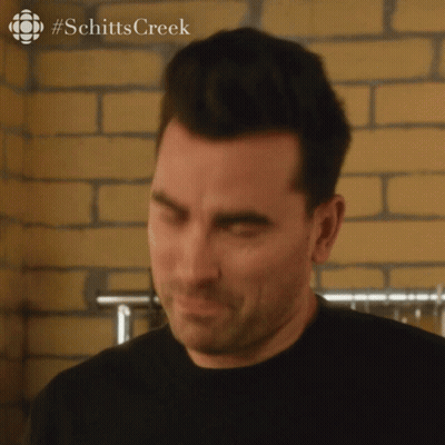 A Close Up Of A Man 'S Face With A #Schitts Creek Logo In The Corner GIF