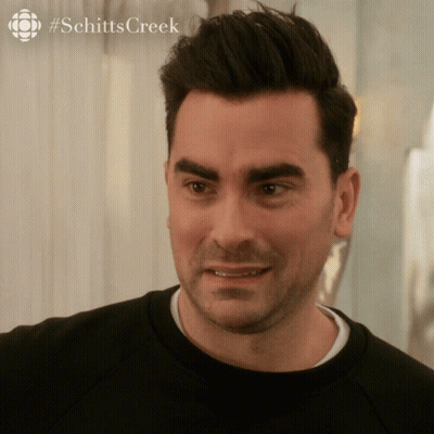 A Close Up Of A Man 'S Face With A #Schitts Creek Logo In The Corner GIF