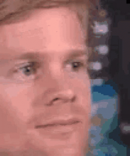A Close Up Of A Man 'S Face With A Serious Expression . GIF