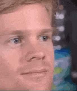 A Close Up Of A Man 'S Face With A Serious Expression On His Face . GIF