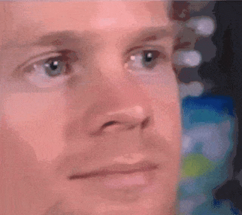 A Close Up Of A Man 'S Face With A Serious Look On His Face GIF