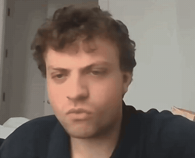 A Close Up Of A Man 'S Face With A Serious Look On His Face . GIF