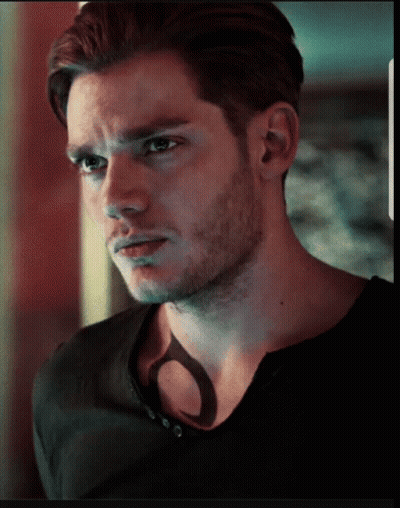 A Close Up Of A Man 'S Face With A Shadow On His Chest GIF