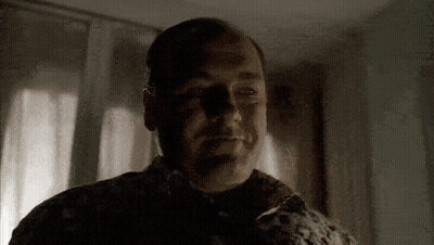 A Close Up Of A Man 'S Face With A Shadow On His Face . GIF