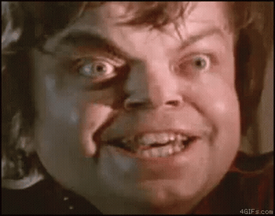 A Close Up Of A Man 'S Face With A Shadow On His Face Making A Funny Face . GIF