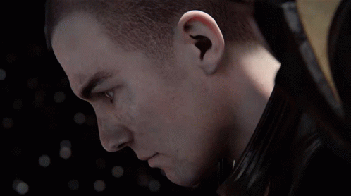 A Close Up Of A Man 'S Face With A Shaved Head And Blue Eyes GIF