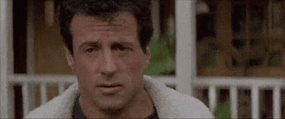 A Close Up Of A Man 'S Face With A Sheep 'S Fur Jacket On . GIF