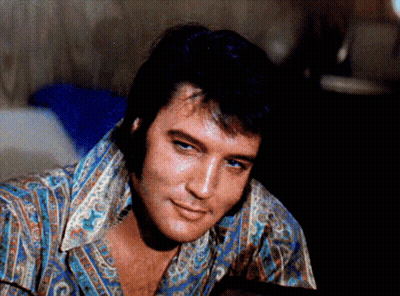 A Close Up Of A Man 'S Face With A Shirt That Says ' Elvis Presley ' On It GIF