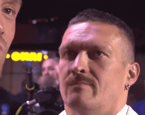 A Close Up Of A Man 'S Face With A Sign Behind Him That Says Casino GIF