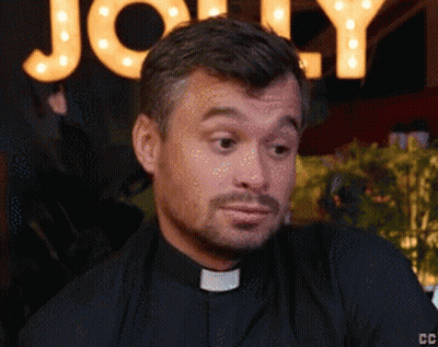 A Close Up Of A Man 'S Face With A Sign Behind Him That Says Jolly GIF
