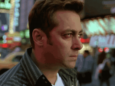 A Close Up Of A Man 'S Face With A Sign In The Background That Says ' Exit ' GIF