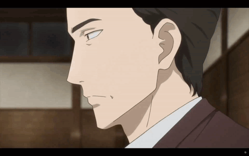 A Close Up Of A Man 'S Face With A Slight Smile On His Face GIF