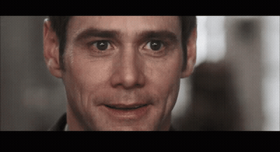 A Close Up Of A Man 'S Face With A Slight Smile On His Face GIF