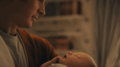 A Close Up Of A Man 'S Face With A Slight Smile On His Face GIF