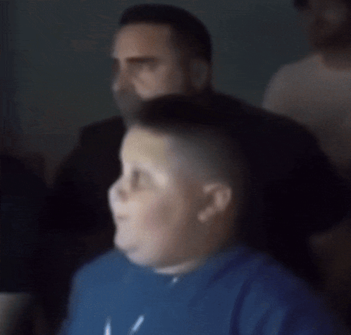 A Close Up Of A Man 'S Face With A Slight Smile On His Face GIF