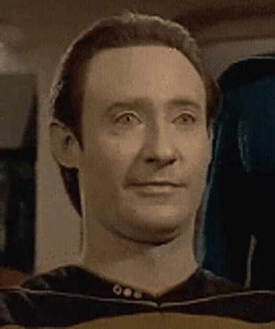 A Close Up Of A Man 'S Face With A Slight Smile On It . GIF
