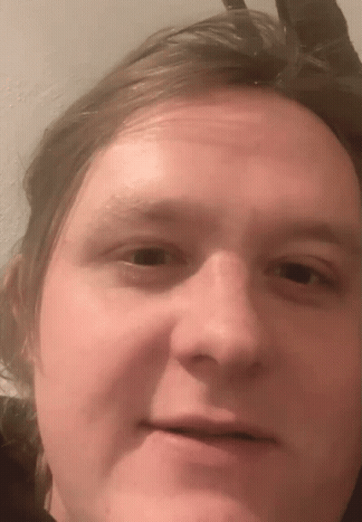 A Close Up Of A Man 'S Face With A Slight Smile GIF