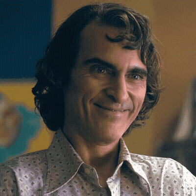 A Close Up Of A Man 'S Face With A Smile On His Face GIF