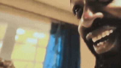 A Close Up Of A Man 'S Face With A Smile On His Face GIF