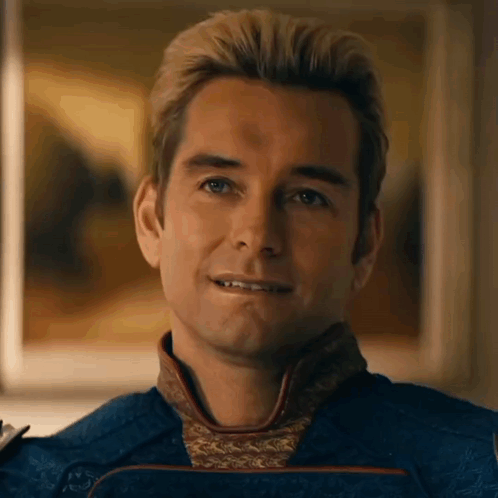 A Close Up Of A Man 'S Face With A Smile On His Face And A Painting In The Background . GIF