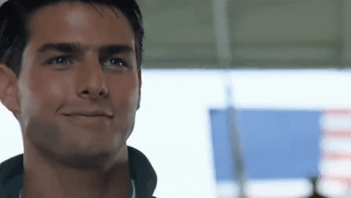 A Close Up Of A Man 'S Face With A Smile On His Face . GIF