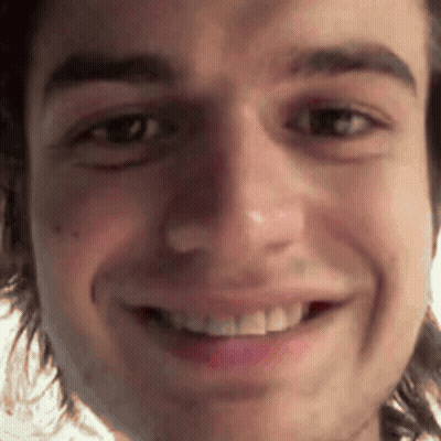 A Close Up Of A Man 'S Face With A Smile On It GIF