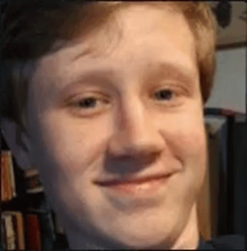 A Close Up Of A Man 'S Face With A Smile On It . GIF