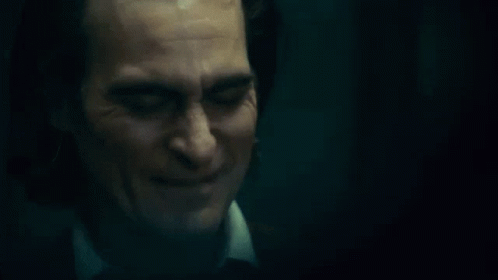 A Close Up Of A Man 'S Face With A Smile On It . GIF