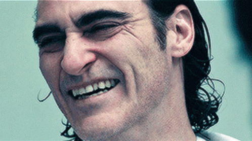 A Close Up Of A Man 'S Face With A Smile On It GIF