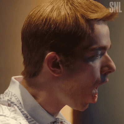A Close Up Of A Man 'S Face With A Snl Logo On His Head GIF