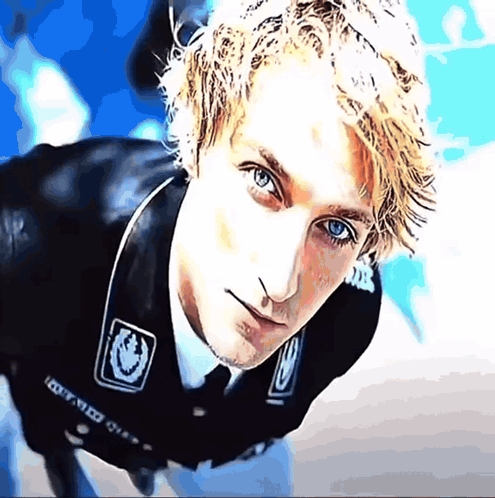 A Close Up Of A Man 'S Face With A Sticker On His Jacket That Says ' I Got Med ' On It GIF