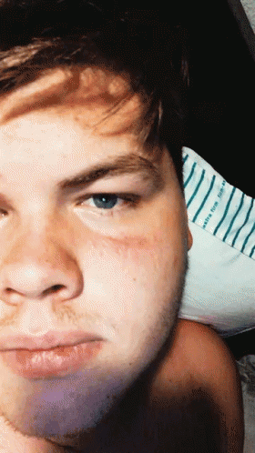 A Close Up Of A Man 'S Face With A Striped Shirt Behind Him That Says ' Happy Birthday ' GIF