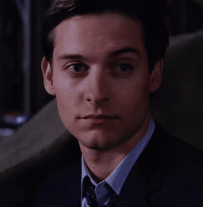 A Close Up Of A Man 'S Face With A Suit And Tie GIF