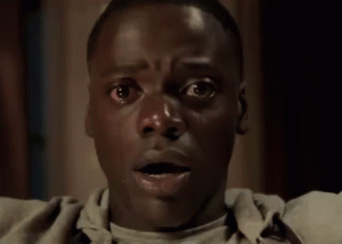 A Close Up Of A Man 'S Face With A Surprised Expression . GIF